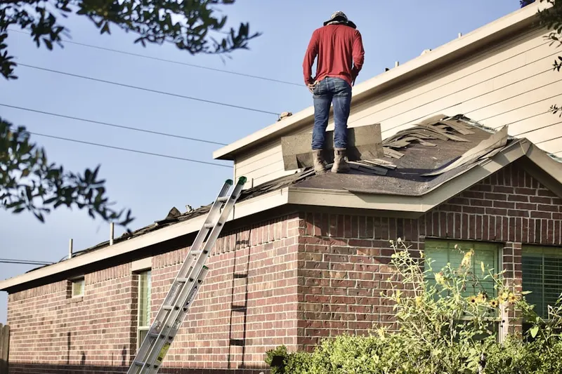 Professional roofer working on a residential roof in Fairlington